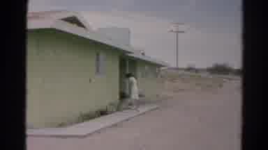 Silver Lake California (1966): Woman In White Dress Watering Plants In A Desert