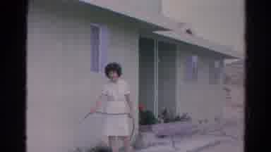 Silver Lake California (1966): A Woman In A Dress Takes The Hose And Waters The