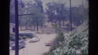 Silver Lake California (1966): Red Car Drives Quickly Down Snow Covered Road