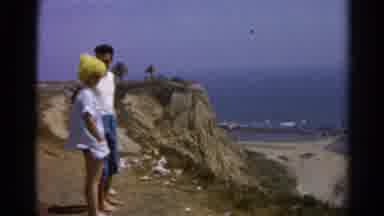 Silver Lake California (1966): Man In Jean Shorts And Woman In Yellow Hat Look At