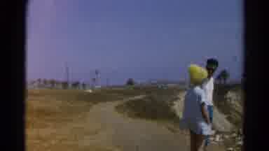 Silver Lake California (1966): Woman In Strange Yellow Hat And Man Stand On An