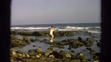 Silver Lake California (1966): Woman In Bathing Suit Walks On Rocks On The Ocean