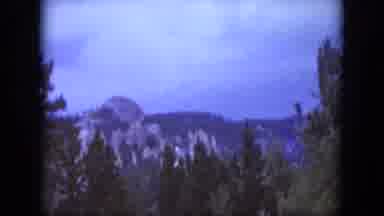South Dakota USA (1966): Walking Through A Wooded Area With Mountains In The