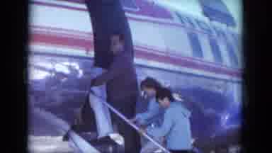 South Dakota USA (1966): People Walking Up Stairs Boarding Airplane Man Looks Back
