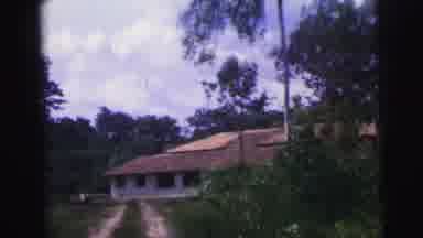Brazil (1967): Footage Approaching A Large House With Lots Of Windows From A Dirt