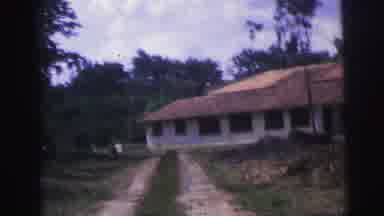 Brazil (1967): Footage Driving Up To A Large House With Lots Of Windows From A
