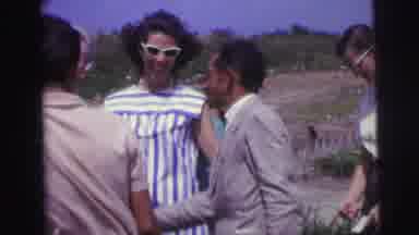 Brazil (1967): Group Of People Chatting Outdoors Near A Lake On A Windy Day
