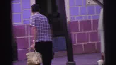 Brazil (1967): A Man Wearing A Checkered Shirt Unloads His Shopping From Car Boot