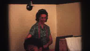 Brazil (1967): Woman With Glasses Places Art Stuff Down And Child Jumps Into