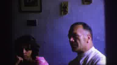 Brazil (1967): Older Man Talks To Camera And Young Couple Plays On The Beach With