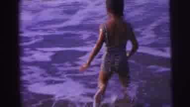 Brazil (1967): Young Child Running Into The Ocean Riding The Waves And Playing In