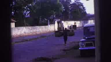 Brazil (1967): A Man Carries A Box On Top Of His Head Followed By A Man Carrying A