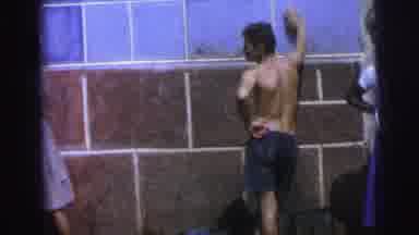 Brazil (1967): Topless Man Posing While He Watches A Woman Carry Something On Her