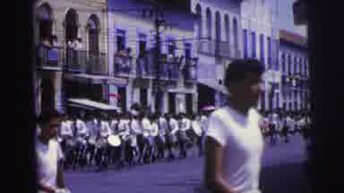 Brazil (1967): Marching Band Walking In Formation Down A City Street Cuts To Close
