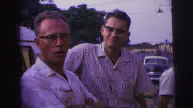 Brazil (1967): Two Men Talking Next To A Parked Car And The Top Of A Catholic