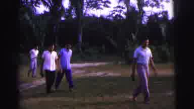 Brazil (1967): Group Of Men Walking Across Lawn Toward Woman At Vehicle