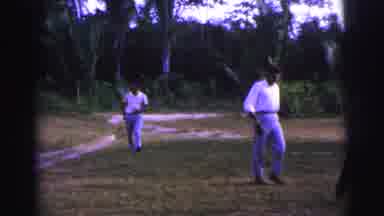 Brazil (1967): People Walking Through A Field Of Grass And Sand Near Palm Trees