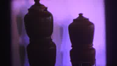 Brazil (1967): Brown Ceramic Pots Stand On Metal Stands In Front Of A White Wall