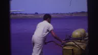 Brazil (1967): Black Man Hauling Equipment While White Woman With Glasses Speaks