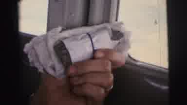 Brazil (1967): A Person Holds A Package Near The Window Of An Aircraft Followed By
