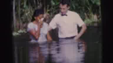 Brazil (1967): A Woman In A Red Dress Touching Her Nose Then A Man And Woman