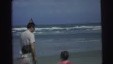Brazil (1967): Man Walking Along Beach Shoreline With Three Children Cuts To A