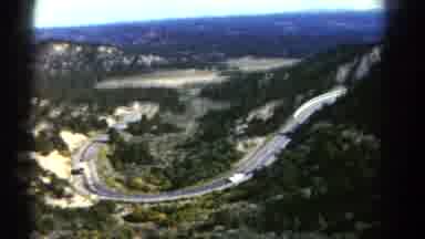 Colorado US (1967): There Are 2 Vehicles Driving On A Paved Highway With Lots Of