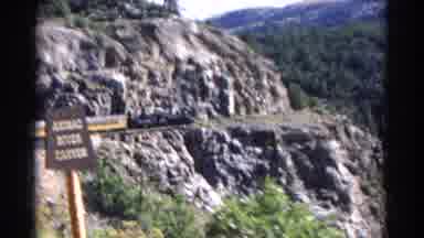 Colorado USA (1967): A Train Going Around A Cliff Up In The Mountains On A Sunny