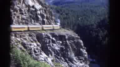 Colorado USA (1967): A Train On The Mountain Going Slow With Smoke Coming Out
