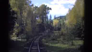 Colorado USA (1967): The Rear View Of Train Tracks As A Train Passes Through A