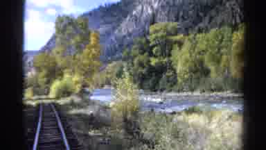 Colorado USA (1967): A Locomotive Going Along A Track Passing Scenery Which