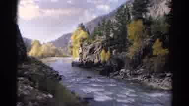 Colorado USA (1967): Train Runs Along The Rails Near A River And You Can See The