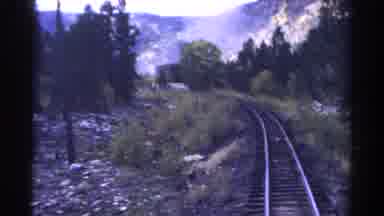 Colorado USA (1967): Looking Back From A Moving Train In A Wooded Mountainous Area