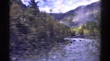 Colorado USA (1967): Medium Sized Shallow River Flowing Through A Forested Area