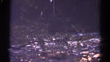 Colorado USA (1967): Water Flowing Over Rocks And Bridge With Rope Rails Near