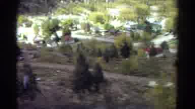 Colorado USA (1967): Camera Panning Over A Valley With Trees Roads Cars And Houses