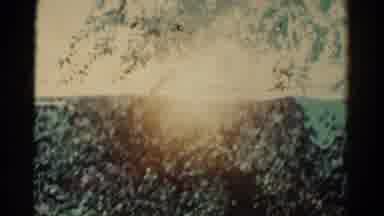 Colorado USA (1967): A Rocky High Cliff With The Reflection Of Trees And Blue Sky