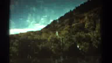 Colorado USA (1967): Tree-Dotted Mountainside And Open Sky With Few Clouds