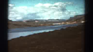 Colorado USA (1967): Going Down The Road While Looking At A Lake And Mountains