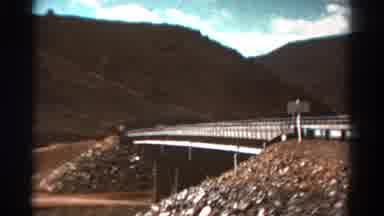 Colorado USA (1967): Moving Footage Of Water Passing Underneath A Bridge Filmed