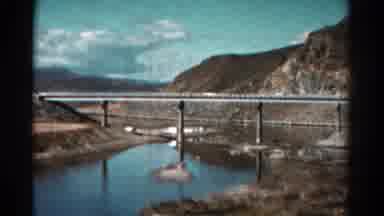 Colorado USA (1967): Scenic View Of A Bridge Over Water Filmed From A Moving Car