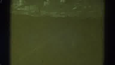Colorado USA (1967): A Vehicle Drives Down A Road In An Unclear And Dark Brown