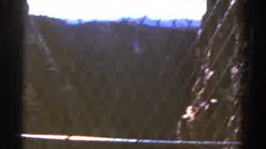 Colorado USA (1967): Dark Footage Of A Cliff Drop And Buildings Behind A Wire