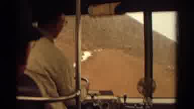 Colorado USA (1967): Bus Driver With Glasses Drives Passengers Along An Old Dirt