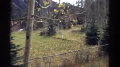 Colorado USA (1967): A Fence Encloses A Rural Home's Yard With Mountains Covered