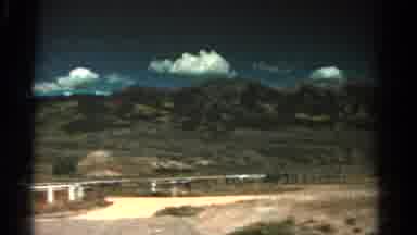 Colorado USA (1967): Car Driving To The Right Filming Distant Mountain Ranges And
