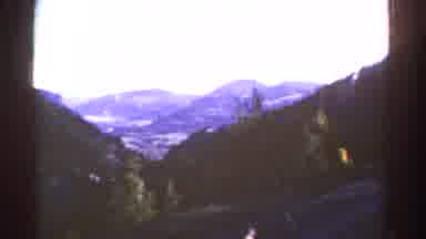 Colorado USA (1967): A Mountain Range On A Curvy Road With Mountains Covered In