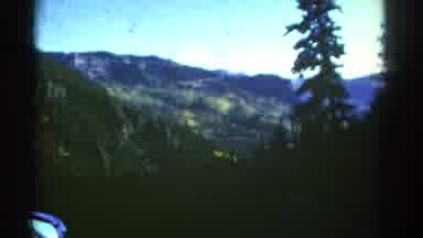 Colorado USA (1967): Rocky Hilltops And Rolling Hills Behind A Forest Of Evergreen