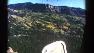Colorado USA (1967): A Large Mountain Range Covered In Trees Being Filmed From The