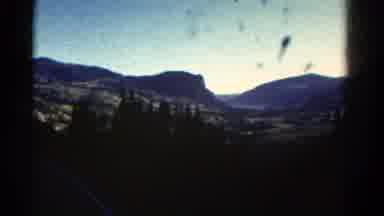 Colorado USA (1967): Flying Bird Trees Mountains Sky Distance Blurry Ground Road